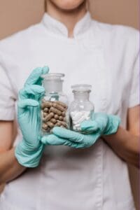 Medical personnel holds two containers of pills, one being Methadone and the other Buprenorphine
