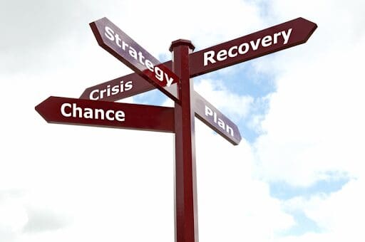 Signpost pointing to recovery and strategy, as it’s important to have relapse prevention strategies in recovery.